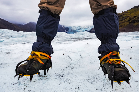冰爪上冻的冰川，瓦特纳冰原的登山者的脚