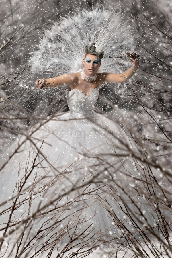 蓝雪发女郎年轻女子冬天公园里的女人雪花美人温特夫人在金色森林里