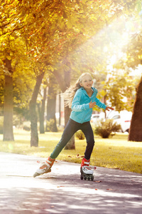 小女孩骑在滚子上，享受阳光明媚的秋天天