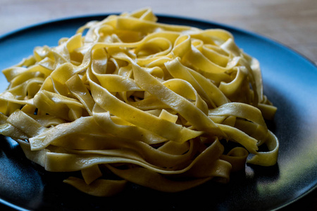 黑色盘子里的普通 tagliatelle 面食