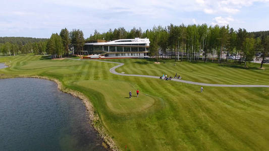与云在蓝色天空和森林湖高尔夫俱乐部，空中的太阳能高尔夫球车。