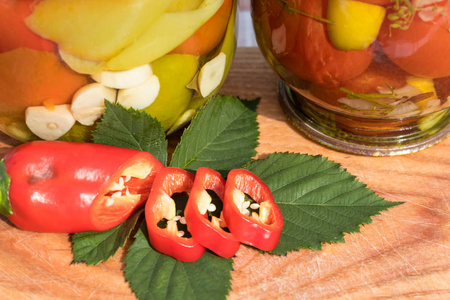 玻璃瓶胡椒豌豆在木板上。辣椒新鲜切。冬天的家庭作业