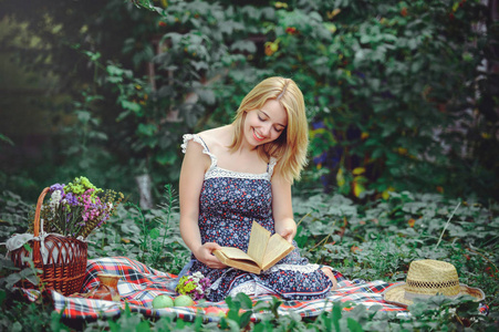 读一本书的性质，深情而温柔的野餐的年轻女人
