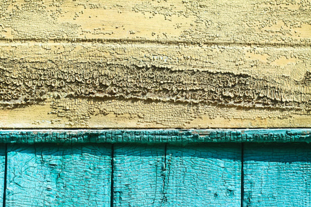 古代的老式木制纹理。绿色 黄色 蓝色的彩色的墙。剥落的油漆。垃圾摇滚彩色背景设计。股票照片