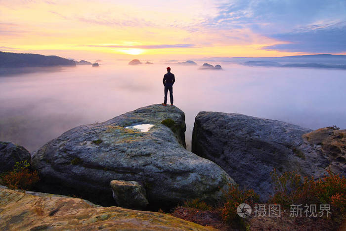 锋利的岩石峰上的后方人剪影满足的徒步旅行者欣赏的