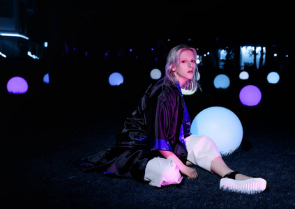 在亚洲风格,夜晚的城市,霓虹灯和时髦的衣服,专业模特拍摄的时尚.