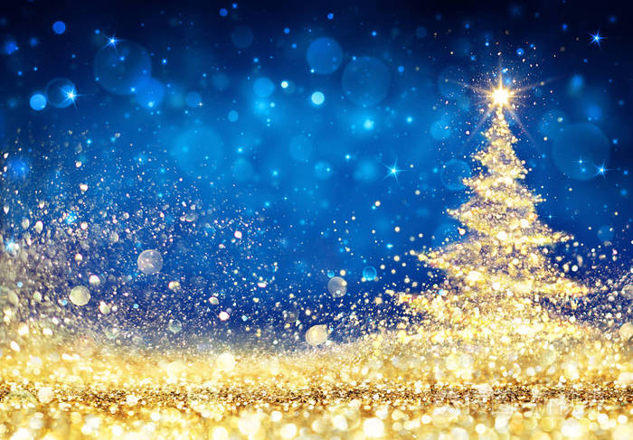 闪闪发光的圣诞树在蓝色背景闪闪发光的金色尘埃