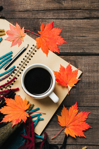 秋天的落叶和一杯咖啡加上旧的老式木制背景格子