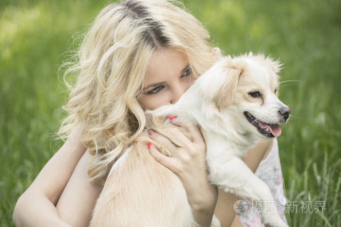 碧眼金发美女躺在与蒲公英草地上.