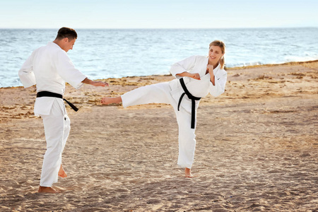 男女练空手道在 karategi 中的运动员都跳动踢裆部杰瑞空手道圆踢年轻