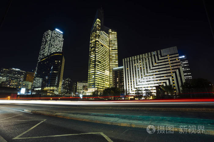 欧洲夜景观动态街道交通, 汽车灯, 玻璃幕墙的现代建筑.
