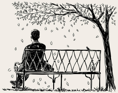 孤独的男人坐在公园的长凳上
