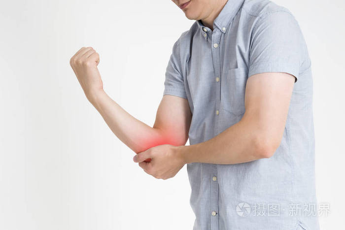 疼痛在手肘联合炎症的灰色背景红色圆点
