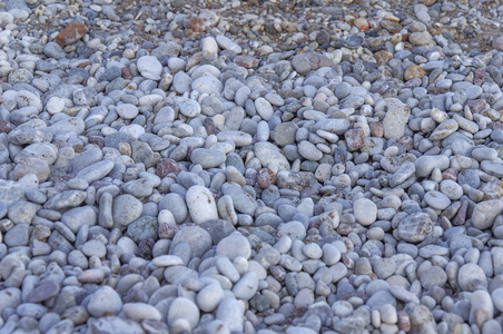 在海滩背景上关闭大量卵石石的纹理