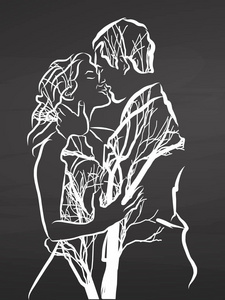 年轻的情侣接吻。在黑板上画画