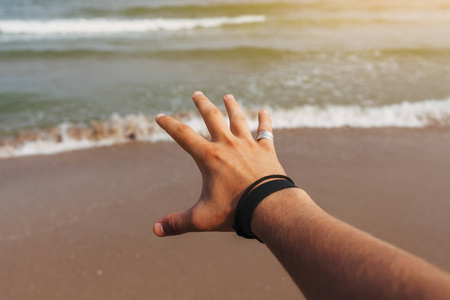 s hand on a background of the sea