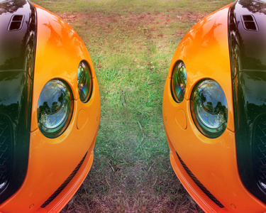 部分橙色汽车在沥青背景。调整.橙色豪华车