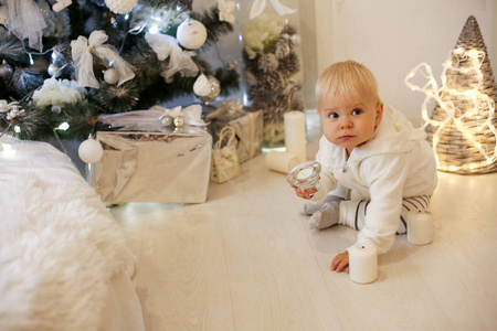 可爱的1岁男婴在舒适的衣服, 摆在新的一年12月