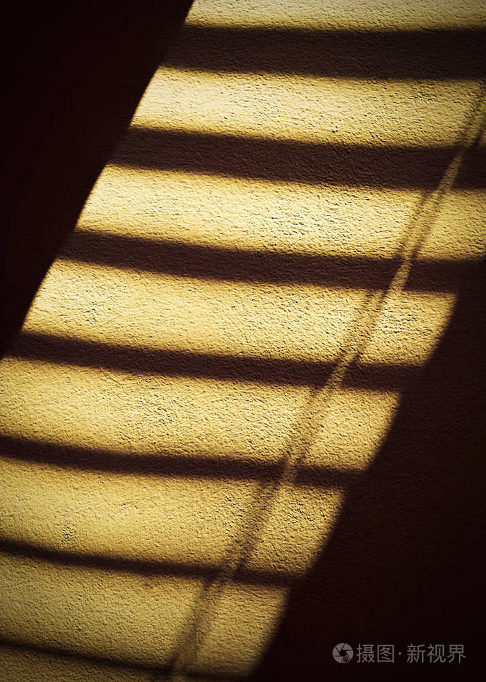 橙色墙上的影子百叶窗