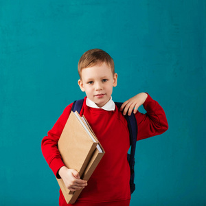 开朗周到的小学校男孩在学校制服与 bac