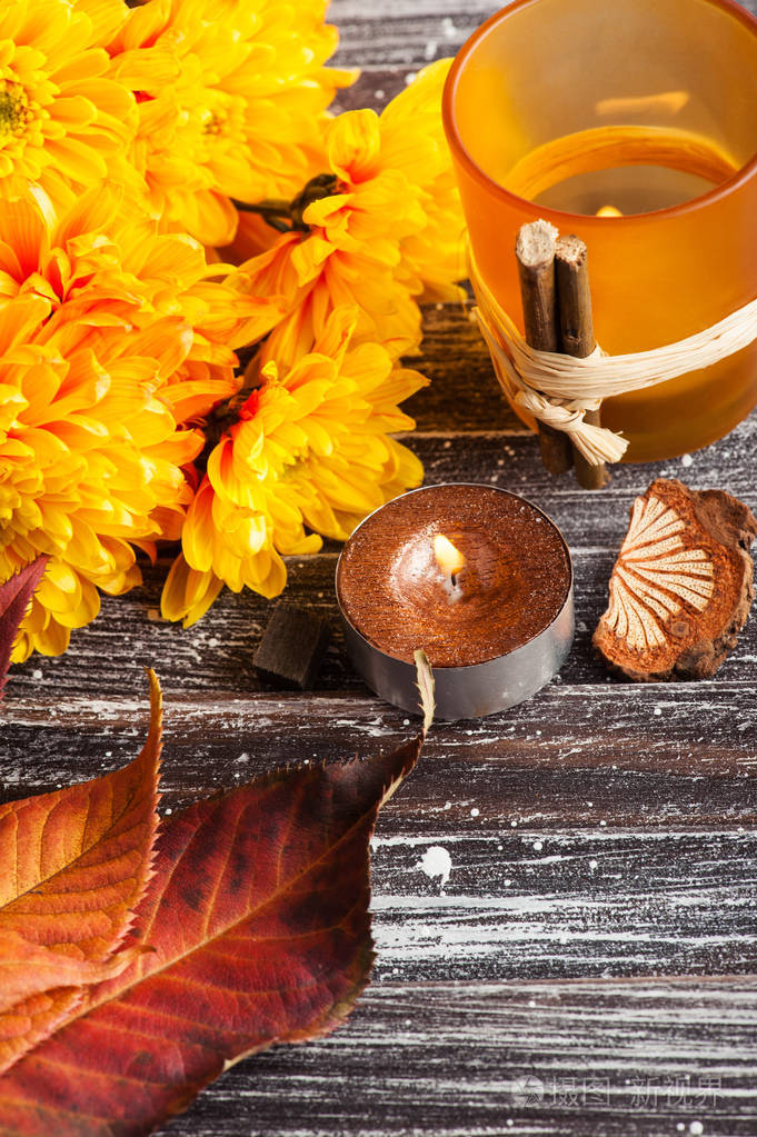 黄菊花点燃金色的蜡烛和树叶