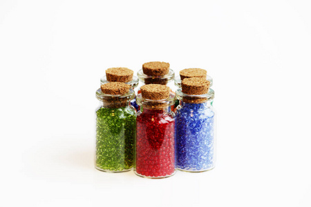 六个小玻璃瓶，瓶塞上有一个白色背景的彩虹色的珠子