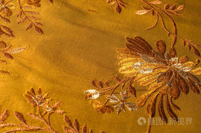 纹理背景图案。 棕色刺绣密集的丝绸织物。