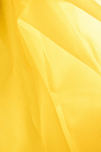 纹理背景图案。 丝绸织物的质地是黄色的。 丝绸织物是透明的。