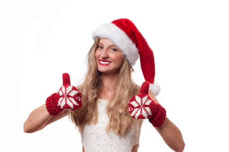 圣诞节.美丽的妇女佩带圣诞老人帽子和手套