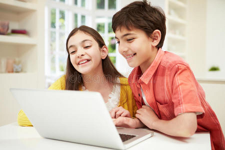 两个西班牙裔孩子在看笔记本电脑