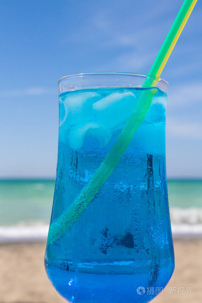 海背景下的蓝色酒精鸡尾酒