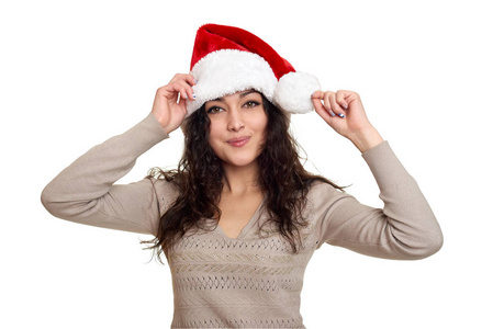 美丽的女孩肖像穿着圣诞老人的帽子。白色隔离背景。新年前夕和寒假概念