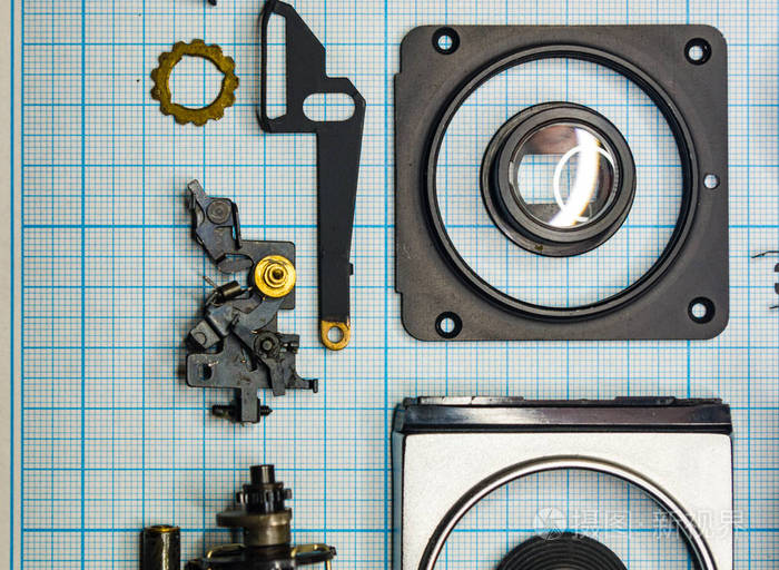 零件完全拆卸旧的复古胶片slr相机在图纸上关闭