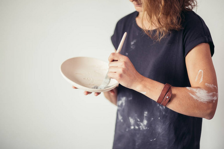 波特妇女油漆陶瓷杯。工作在她的陶艺工作室的妇女