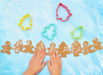 s hands and christmas cookies on a blue background