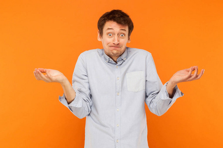 s. Confused man looking at camera. Studio shot, orange backgroun