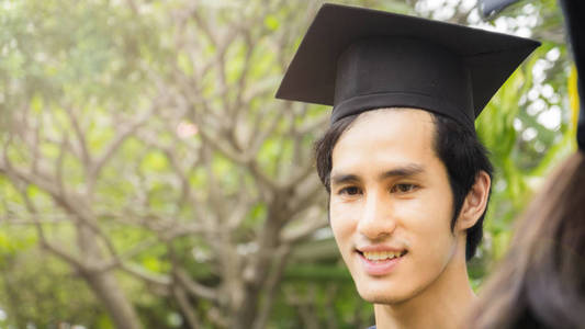 人学生的微笑和快乐毕业袍和帽的感觉