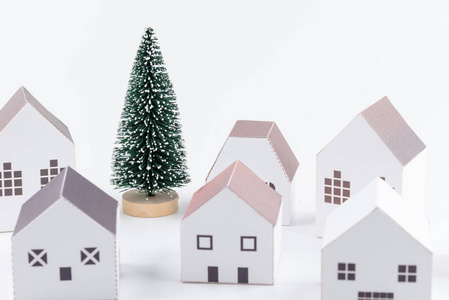 圣诞树在纸屋小镇孤立的白色背景与复制空间。圣诞节概念