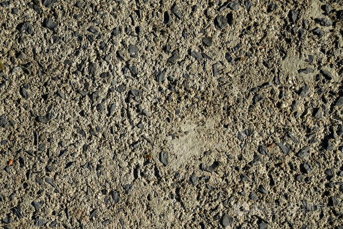 阳光下灰色水泥遮阳和石材路面路面地面粗糙表面纹理背景