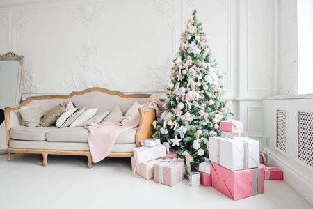 美丽的现代设计的房间在精致的浅色装饰圣诞树和装饰元素