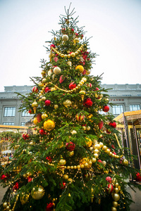 s tree, decorated with golden and red balls, beads and tinsel