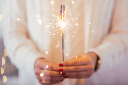 s  hands holding sparkler