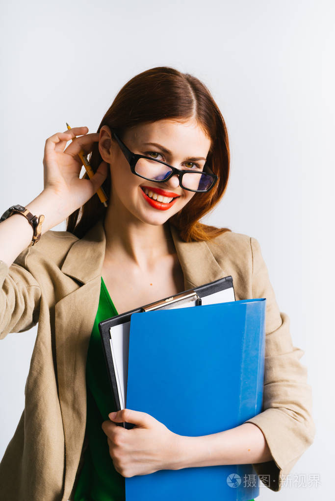 戴眼镜的商业女孩手里拿着一个文件夹, 微笑着