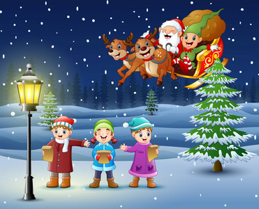 圣诞老人带着圣诞老人在雪地里唱歌的快乐孩子的矢量图照片