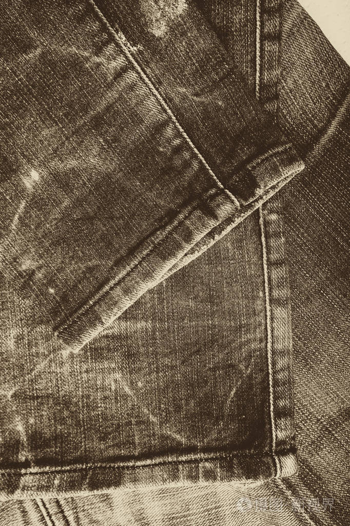 粗斜纹棉布牛仔裤背景与煤层的牛仔裤时尚设计