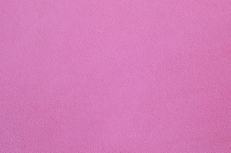 浅粉红色软毛绒材料的背景纹理照片