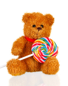 棕色泰迪熊与棒棒糖分离白色背景