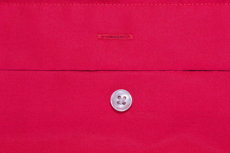 一个红色的棉质纤维表面形成一个织物, 钮扣是缝制的面料, 抽象的背景