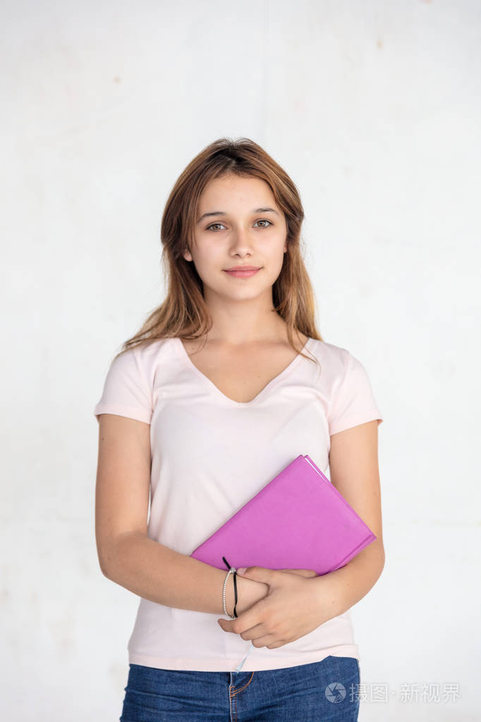 白种人的女青少年拿着笔记本孤立在白色背景上