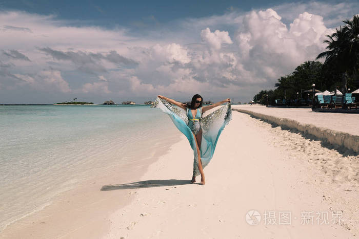 马尔代夫岛上优雅沙滩服装的女性